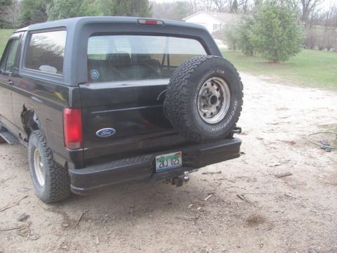 1996 Ford Bronco - The rear of a black 1996 Ford Bronco is shown, complete with a spare tire and a license plate.