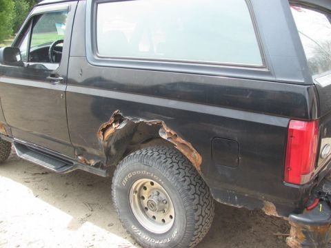 1996 Ford Bronco - This 1996 Ford Bronco displays extensive rust damage, particularly on its rear fender and lower body panels.