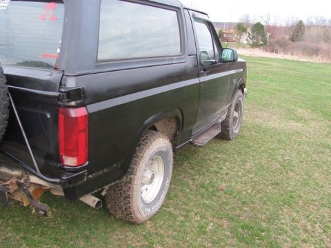 1996 Ford Bronco - This 1996 Ford Bronco is viewed from the rear quarter panel, showing its side profile and off-road tires.