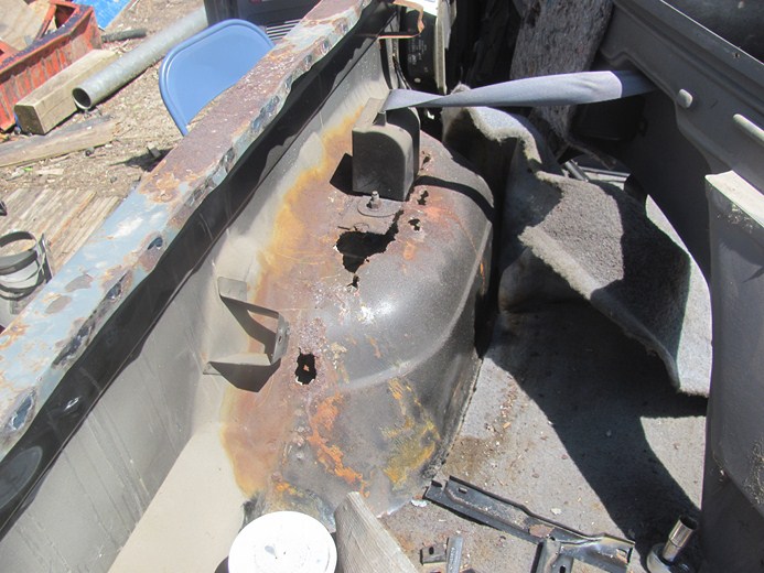 Rusted interior wheel well and frame with visible Supermotors.net logo