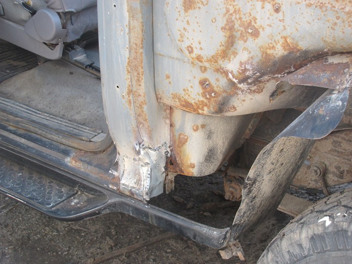 rusted door frame and interior of a vehicle, showing damage and wear