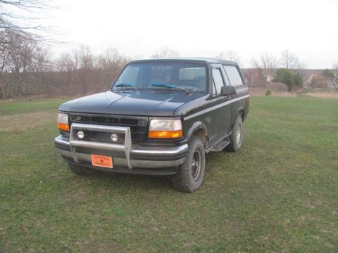 1996 Ford Bronco - This 1996 Ford Bronco is shown from the front three-quarter view on a grassy field.