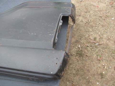 1996 Ford Bronco - Close-up of a dark gray rear bumper corner, showing the area where a taillight would be mounted.