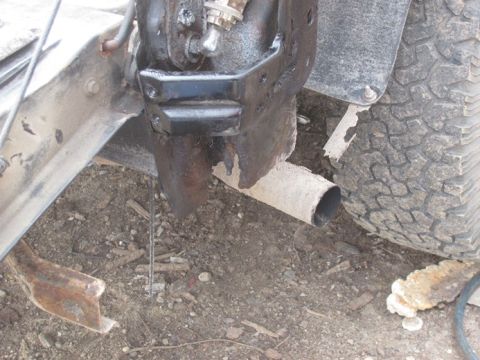 1996 Ford Bronco - This image shows a portion of a vehicle's exhaust system and a tire, not a complete vehicle.