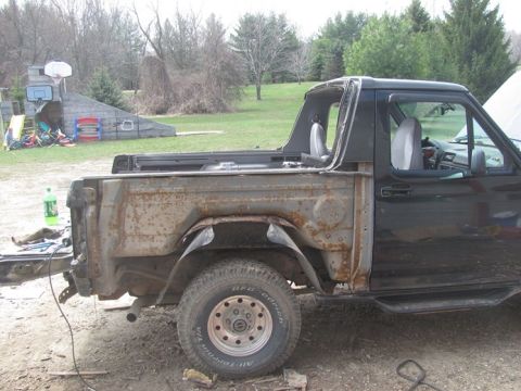 1996 Ford Bronco - This heavily modified Ford Bronco shows significant rust and missing body parts, indicating it is not a 1996 model.