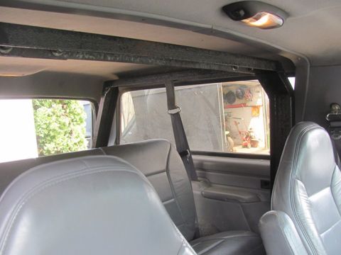 1996 Ford Bronco - Interior of a 1996 Ford Bronco, grey leather seats and an aftermarket roll cage.