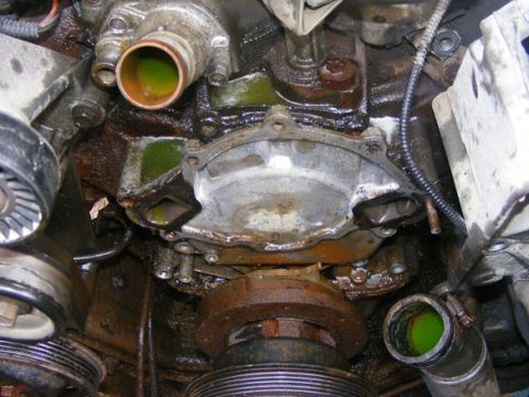 1996 Ford Bronco - Close-up view of a vehicle's engine water pump and associated components, showing signs of coolant leakage.