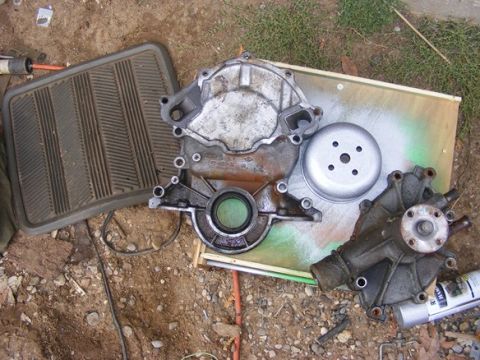 1996 Ford Bronco - Various engine components are disassembled and placed on the ground for inspection or repair.