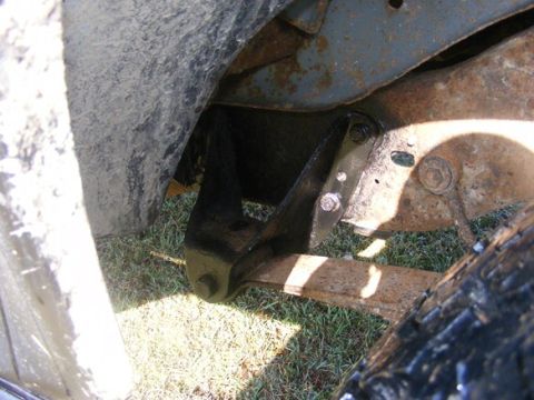 1996 Ford Bronco - Close-up view of a black suspension bracket attached to the frame of a vehicle.