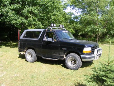 1996 Ford Bronco - Black 1996 Ford Bronco with aftermarket accessories sits on a grassy lawn.