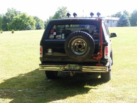 1996 Ford Bronco - This Ford Bronco is equipped with a rear-mounted spare tire and a Hi-Lift jack, suggesting off-road use.