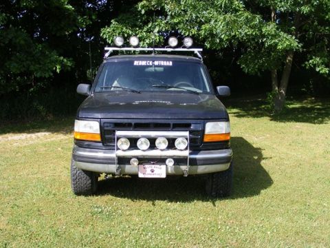 1996 Ford Bronco - This black Ford Bronco features a roof rack and auxiliary lights on the front bumper.