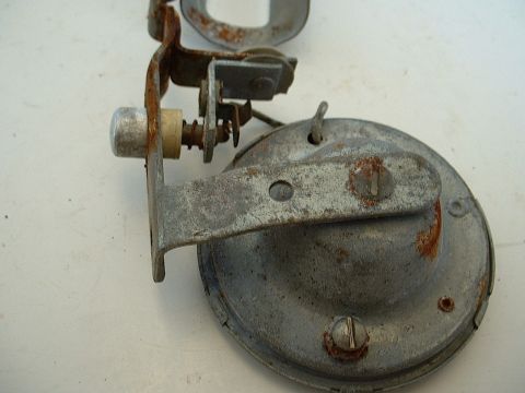 1994 Ford Bronco - Close-up view of a corroded automotive horn assembly, showing its mechanical components and wear.