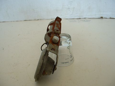 1994 Ford Bronco - A close-up of a corroded metal component resting on a glass measuring cup.