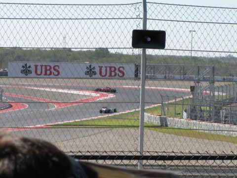 2006 BMW 5 Series - Race cars compete on a track, with UBS branding visible on a large sign.