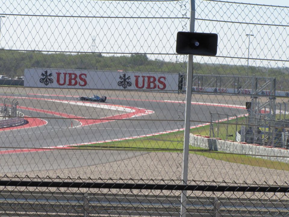 Race car on a track with UBS advertising in background