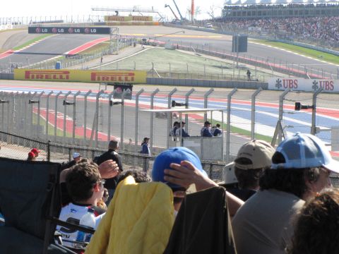 2006 BMW 5 Series - A race track event with spectators in the foreground and banners along the track.