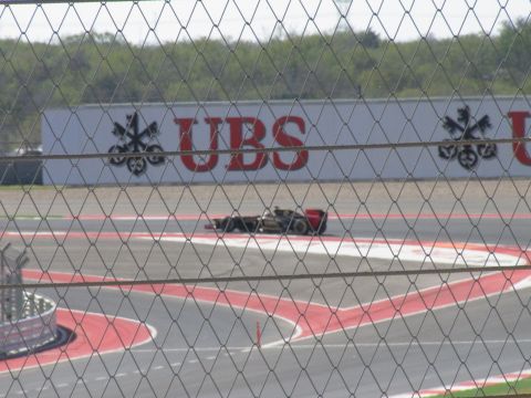 2006 BMW 5 Series - A race car drives on a track with a UBS advertisement visible on a wall behind it.