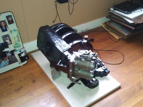 1990 Ford Bronco - Edelbrock intake manifold for electronic fuel injection is displayed on a wooden floor.