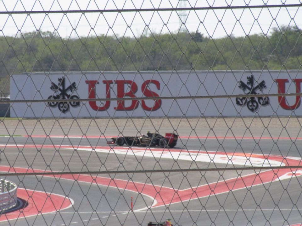Formula 1 race car on track with UBS advertisement
