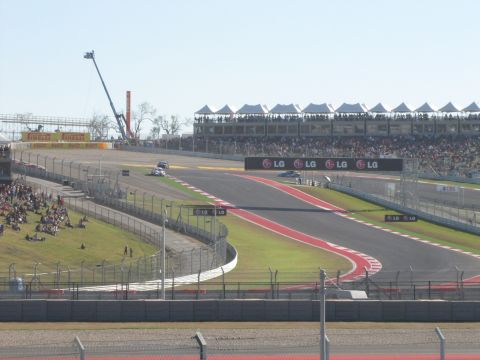 2006 BMW 5 Series - Two race cars are visible on a track with spectators in the grandstands and LG advertisements.
