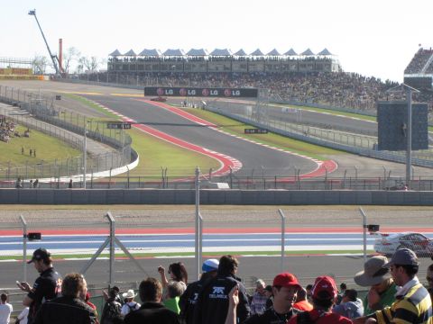 2006 BMW 5 Series - Spectators watch a race at a circuit with LG branding visible on the grandstands.
