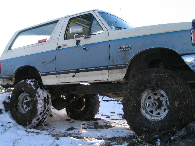 Ford Bronco with large tires on snowy ground