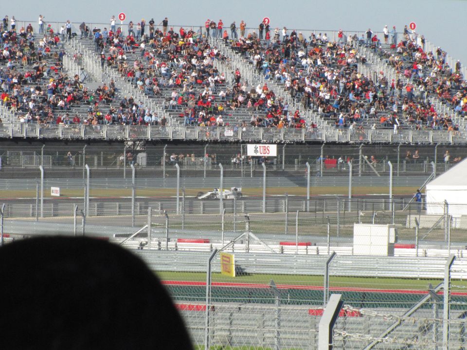 Formula 1 race car on a track with spectators in the stands