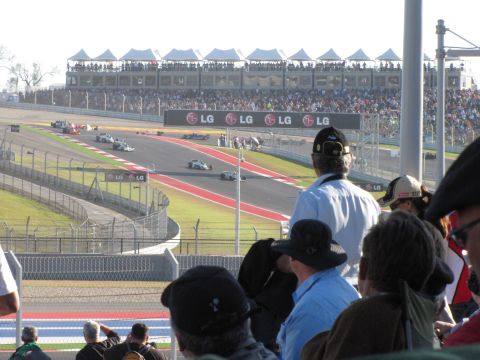 2006 BMW 5 Series - A race is underway at the Circuit of the Americas, with spectators watching from the stands and LG advertisements visible on the trackside.