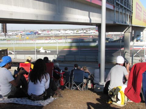 2006 BMW 5 Series - Spectators watch race cars on a track from under a grandstand at the Circuit of the Americas.