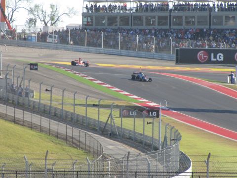 2006 BMW 5 Series - Race cars compete on a track with spectators in the grandstands and LG advertisements visible.