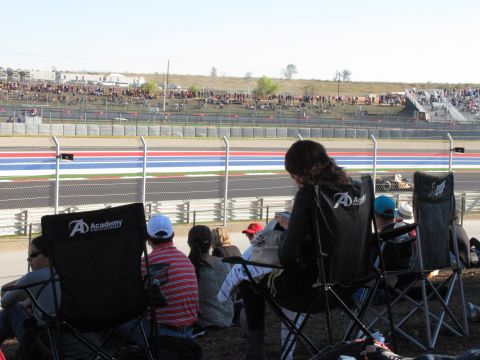 2006 BMW 5 Series - Spectators watch a race car on a track at the Circuit of the Americas.