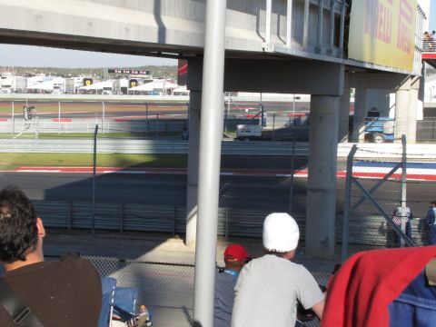 2006 BMW 5 Series - View of a race track from the stands, with spectators in the foreground.