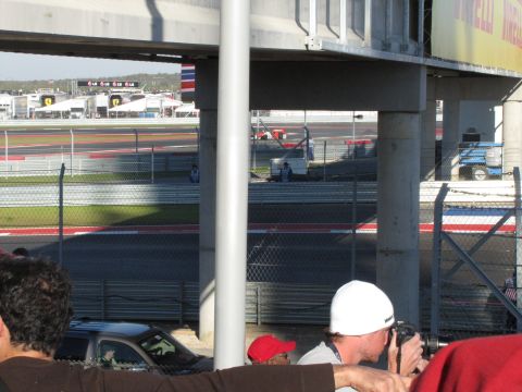 2006 BMW 5 Series - A view of a race track with spectators and various structures in the background.