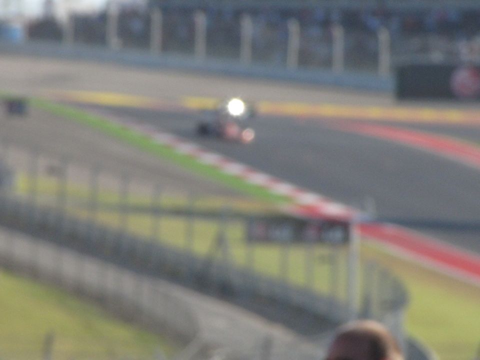 Race car on a track with a bright headlight