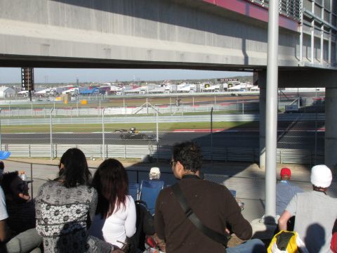 2006 BMW 5 Series - Spectators watch a race car on a track at the Circuit of the Americas.