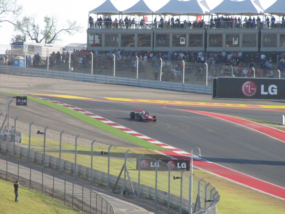 Race car on a track with spectators in the background and LG branding