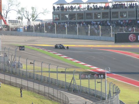 2006 BMW 5 Series - A Formula 1 race car navigates the track at the Circuit of the Americas, with prominent LG branding visible.