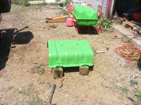 1996 Ford Bronco - Two green fuel tanks are visible in a yard, one resting on wooden blocks and the other on a crate.