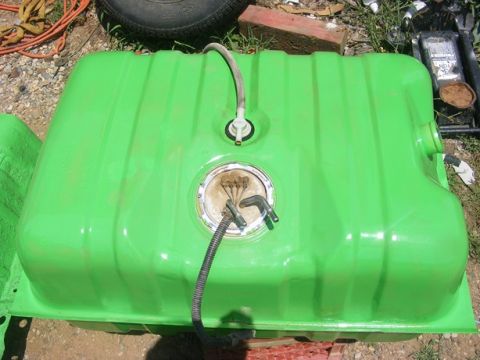 1996 Ford Bronco - A green fuel tank with visible hoses and a fuel pump assembly is shown outdoors.