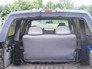 1996 Ford Bronco - The interior rear view of an SUV reveals folded seats and the cargo area.