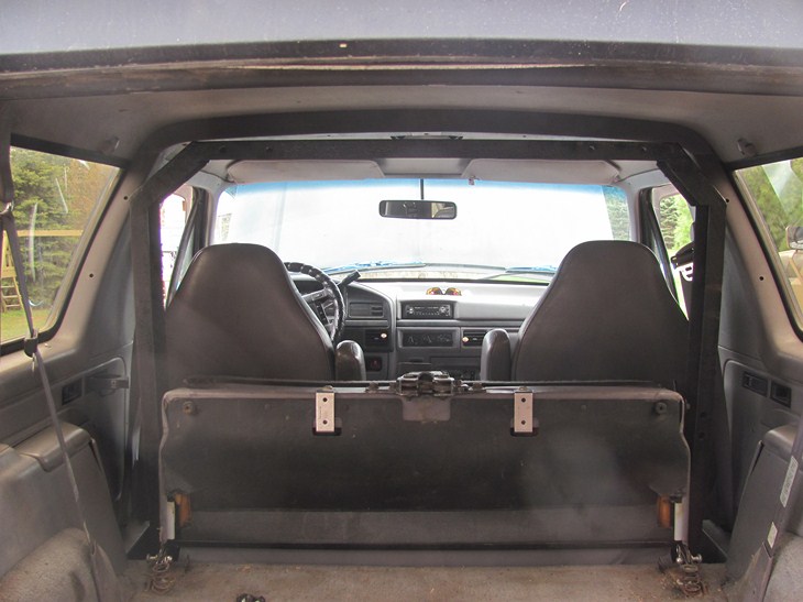 Interior view of a 1992 Ford Bronco showing front seats, dashboard, and rear cargo area
