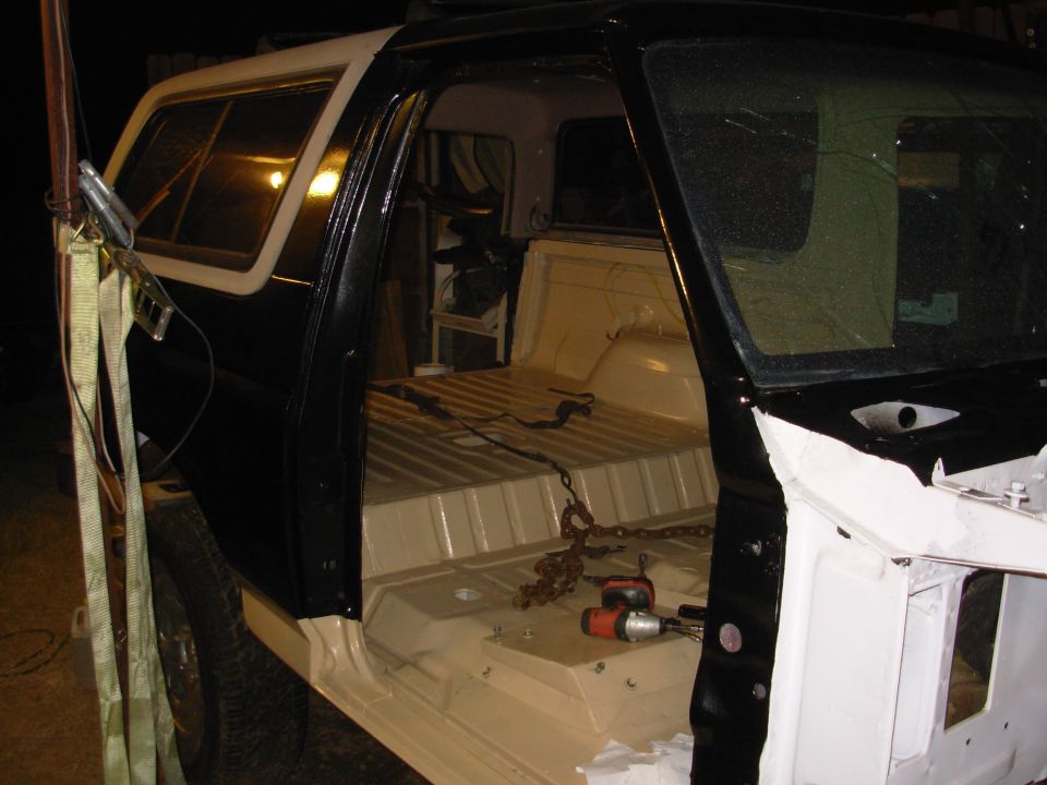 Since (I THINK) everything underneath is done, the body is now bolted down.  The camper is just set on to keep some of the sun & rain out.  The poly body mounts are glued in-place, and the factory steel sleeves have washers welded on top to keep the bolts centered, so the body should be perfectly positioned, and never shift.  I had to trim some of the rear bumper splash shield, but I'll clean it up when I powder that bumper (one of these years).