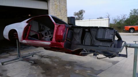 1970 Ford Mustang - Car body undergoing restoration, mounted on a rotisserie for easier access to all sides.