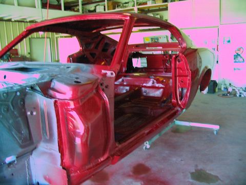 1970 Ford Mustang - Body shell of a 1970 Ford Mustang in a workshop, likely during a restoration project.