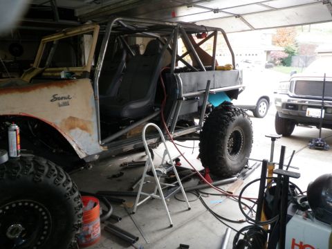 1961 International Scout 800 - Customized 1961 International Scout 800 undergoing modifications in a garage setting.