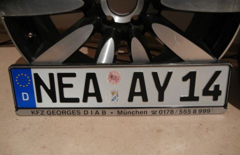 1999 Lincoln Town Car - A German license plate is shown in front of a car wheel, with dealer information at the bottom.