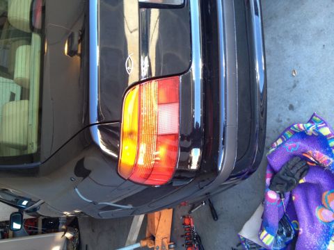 1999 BMW 5 Series - The rear of a black 1999 BMW 5 Series is visible, supported by a jack.