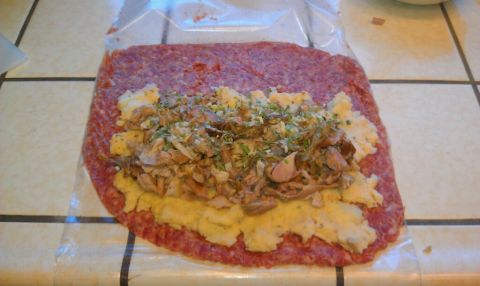 1989 Ford Bronco - A raw meatloaf is prepared with a filling of mashed potatoes and shredded meat, ready for cooking.