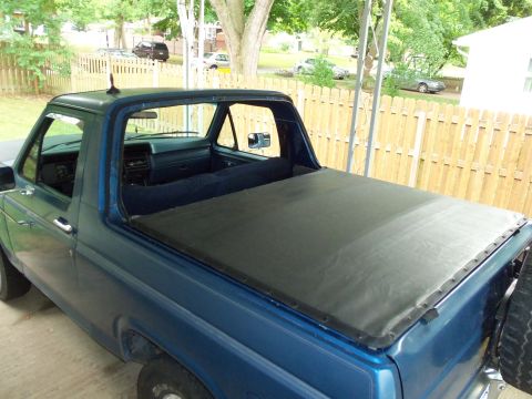1985 Ford Bronco - This blue pickup truck appears to be a 1987 model, not a 1985 Ford Bronco.